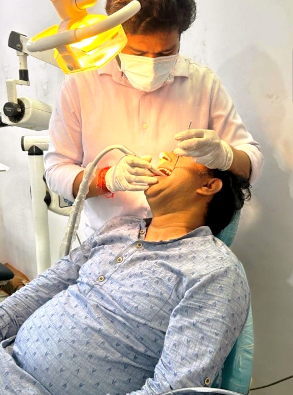 Dr. Shubham Shukla treating a patient at Amravati Dental Clinic